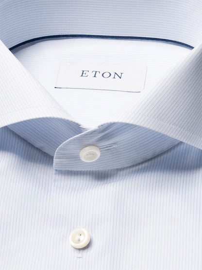Close-up of the Eton Slim Fit Striped Twill Dress Shirt in Light Blue, featuring crease-resistant cotton twill, white buttons, and a visible Eton label inside the collar.