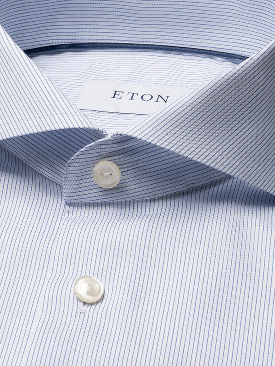 Close-up of an Eton Slim Fit Striped Twill Dress Shirt in dark blue, featuring fine vertical stripes, white buttons, an extreme cut away collar, and the visible "ETON" label inside the collar.