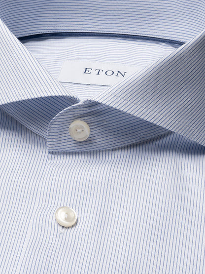 Close-up of an Eton Slim Fit Striped Twill Dress Shirt in dark blue, featuring fine vertical stripes, white buttons, an extreme cut away collar, and the visible "ETON" label inside the collar.