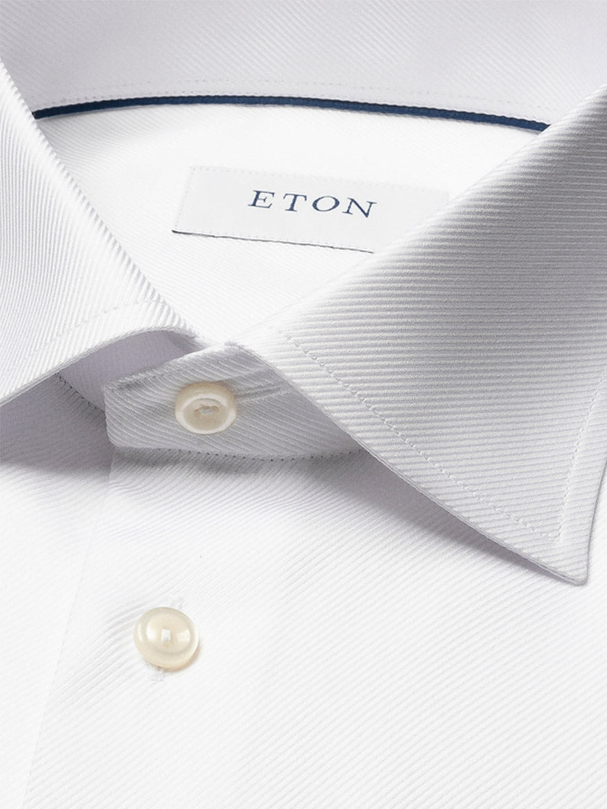 Close-up of the Eton Slim Fit Solid Textured Twill Dress Shirt in White, featuring a pointed collar, pearl buttons, single cuff, and visible brand label—ideal for sharp business attire.