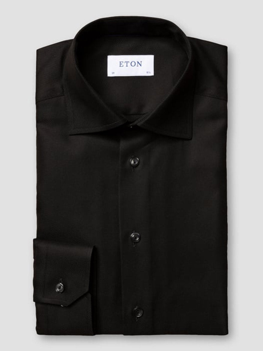 The Eton Slim Fit Black Textured Twill Dress Shirt features a classic collar, buttoned cuffs, and an "ETON" label inside—ideal for polished business attire.