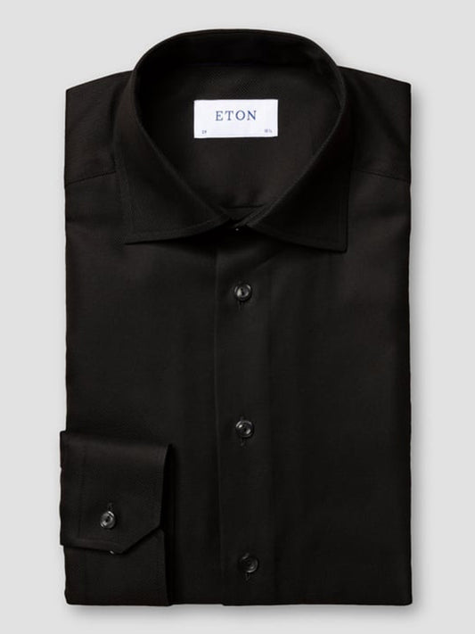 The Eton Slim Fit Black Textured Twill Dress Shirt features a classic collar, buttoned cuffs, and an "ETON" label inside—ideal for polished business attire.