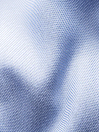 Close-up of light blue textured twill fabric with diagonal ribbing and soft folds, highlighting the refined weave of the Eton Slim Fit Solid Textured Twill Dress Shirt in Light Blue.