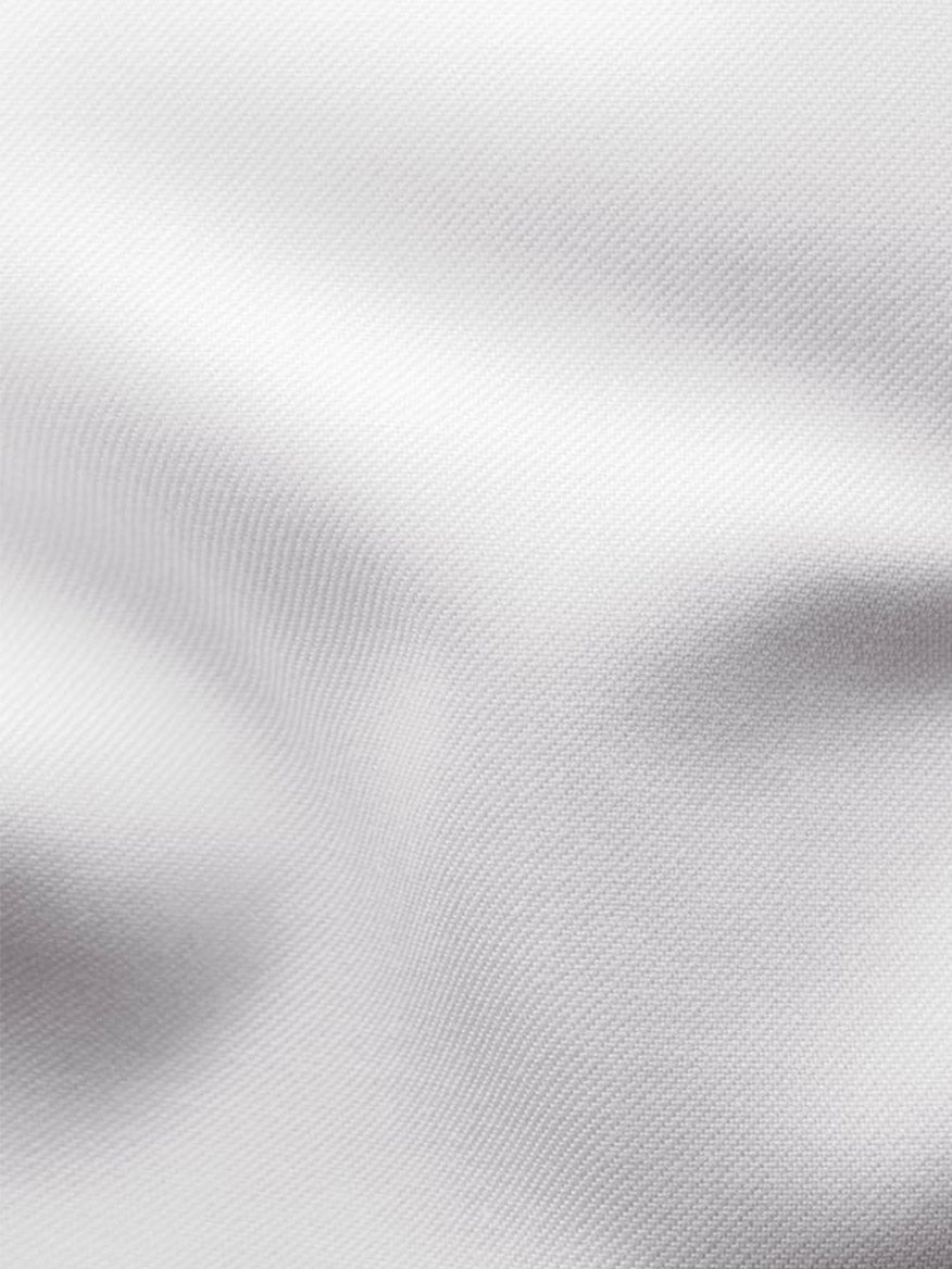 Close-up of the Eton Slim Fit Signature Twill Dress Shirt in White with Blue Details, highlighting its fine fabric, subtle folds, and soft shadows—ideal for a wrinkle-resistant, tailored look.
