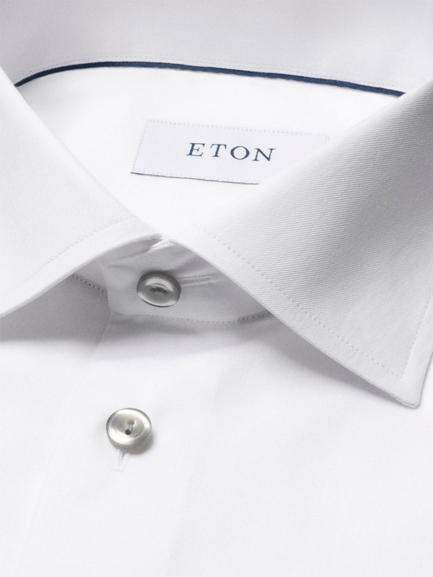 Close-up of the Eton Slim Fit Signature Twill Dress Shirt in White with Grey Details, featuring a spread collar, two buttons, and an "ETON" label inside. Made from wrinkle-resistant Signature Twill fabric for a stylish look.