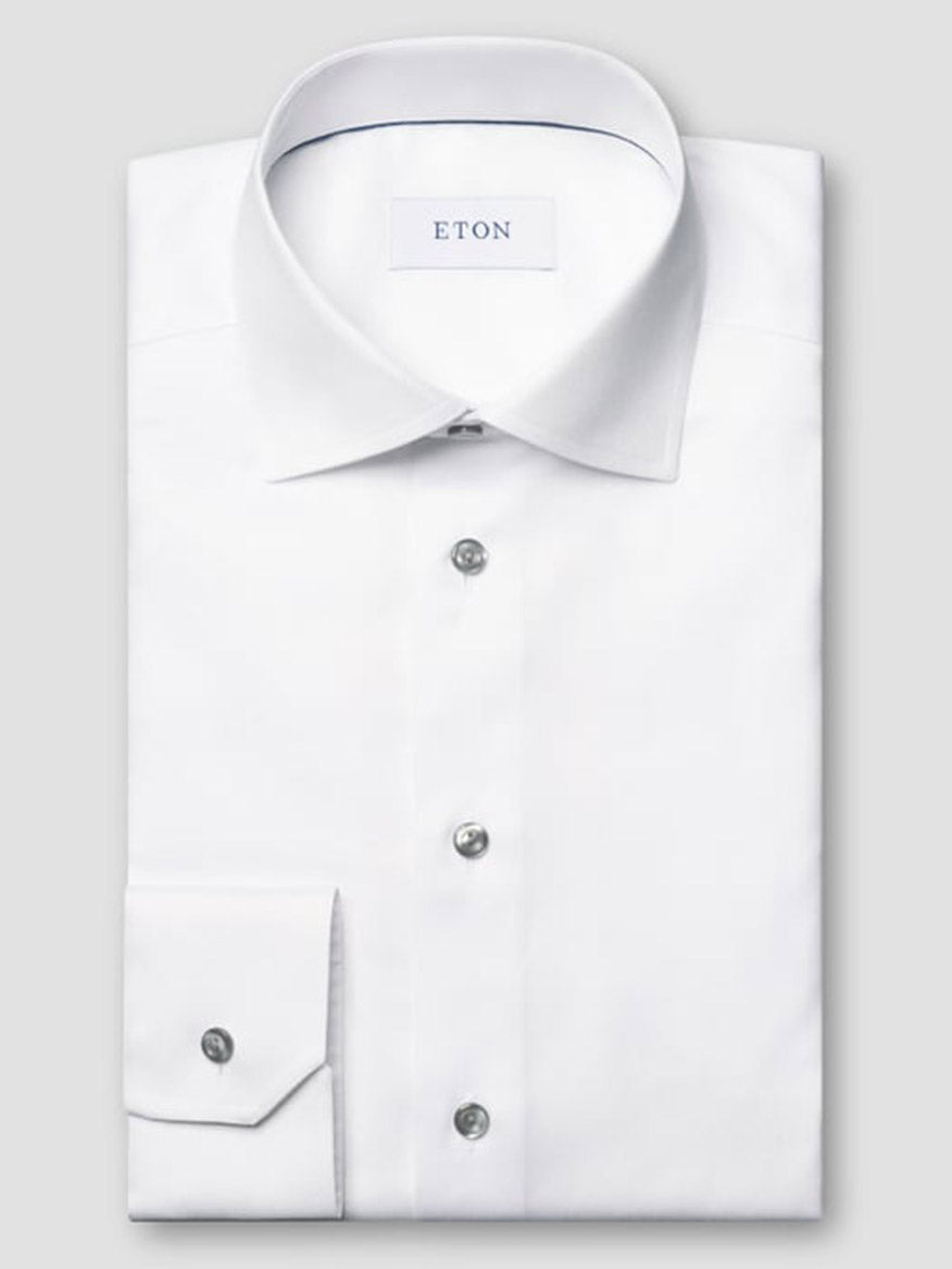 The Eton Slim Fit Signature Twill Dress Shirt in white features grey details, a classic collar, buttoned cuffs, wrinkle-resistant fabric, and the "ETON" label inside the collar.
