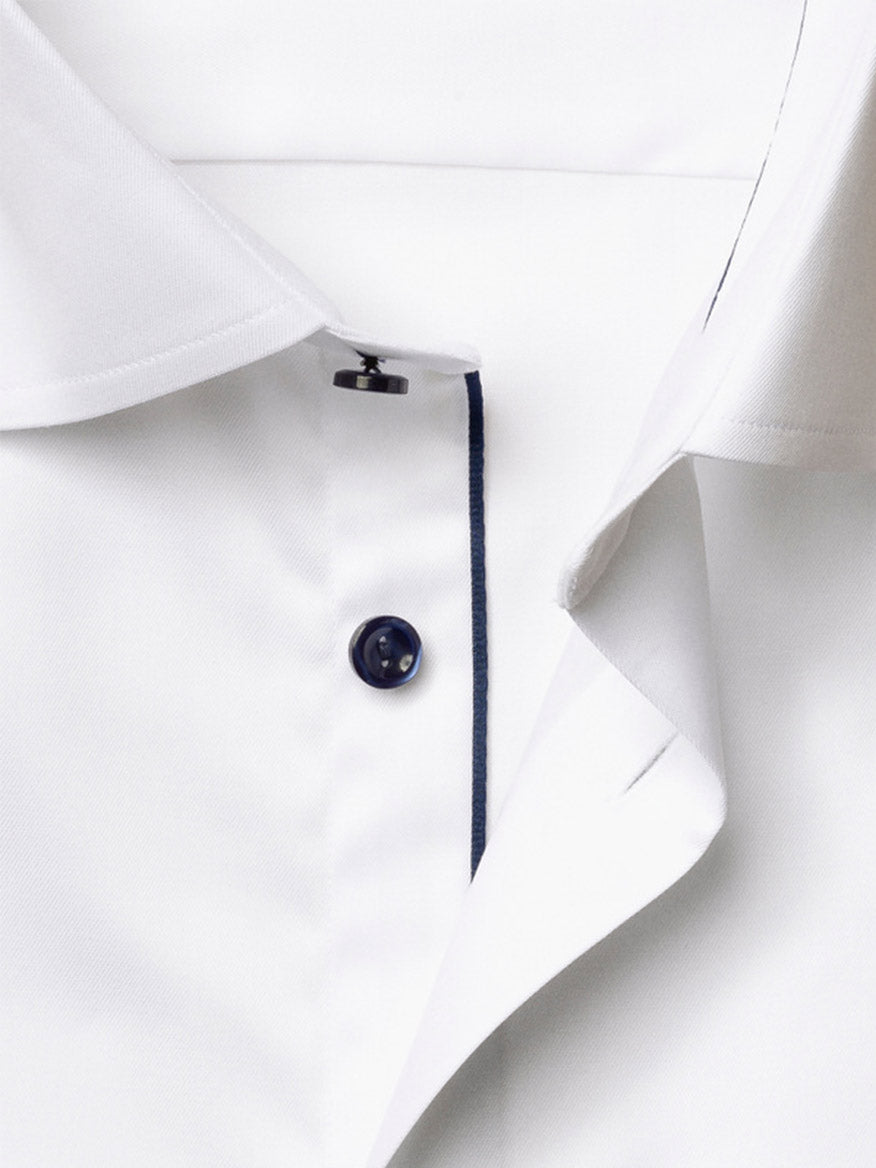 Close-up of the Eton Contemporary Fit Solid Signature Twill Dress Shirt in white, featuring a folded collar, dark button, and navy trim along the button placket.