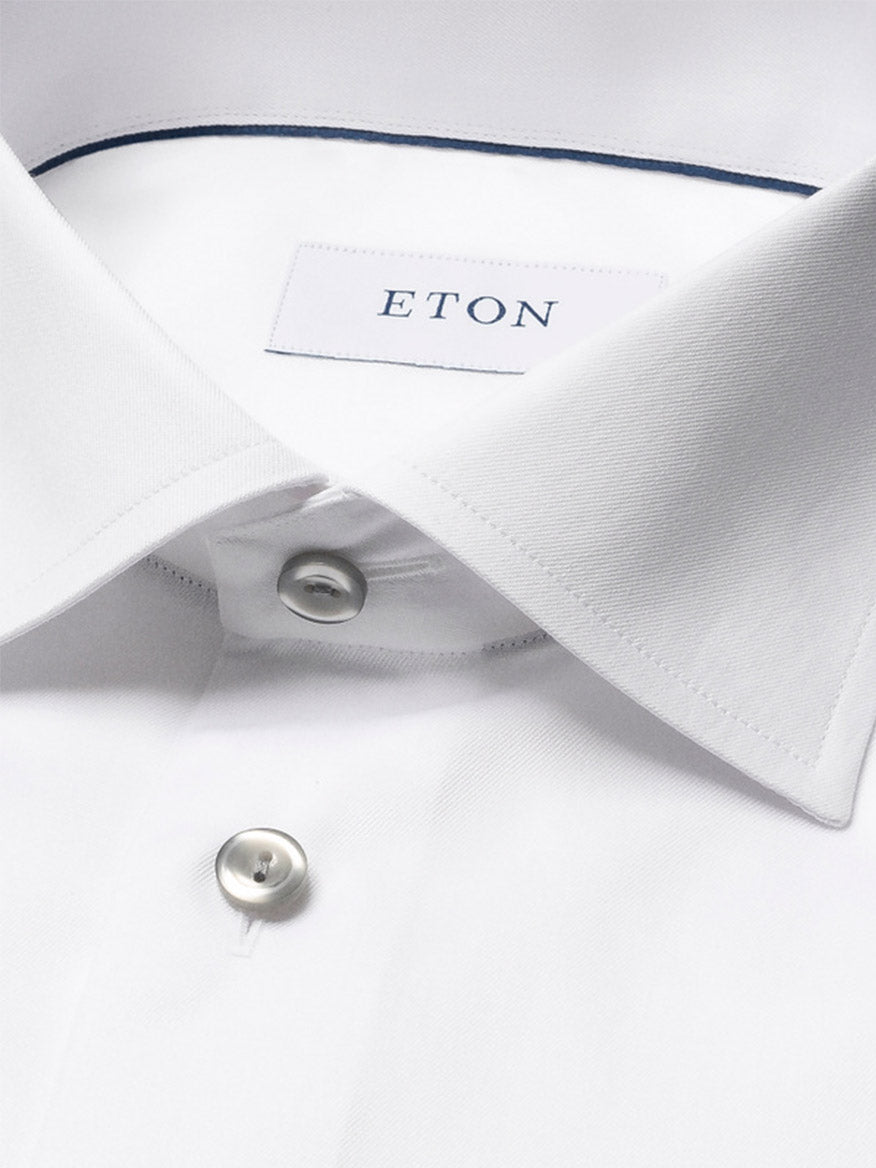 Close-up of the Eton Contemporary Fit White Twill Dress Shirt, featuring a classic collar, two visible buttons, grey details, and signature Eton twill fabric.