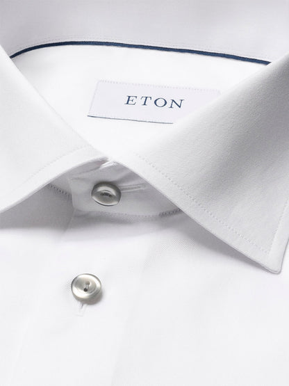 Close-up of the Eton Contemporary Fit White Twill Dress Shirt, featuring a classic collar, two visible buttons, grey details, and signature Eton twill fabric.