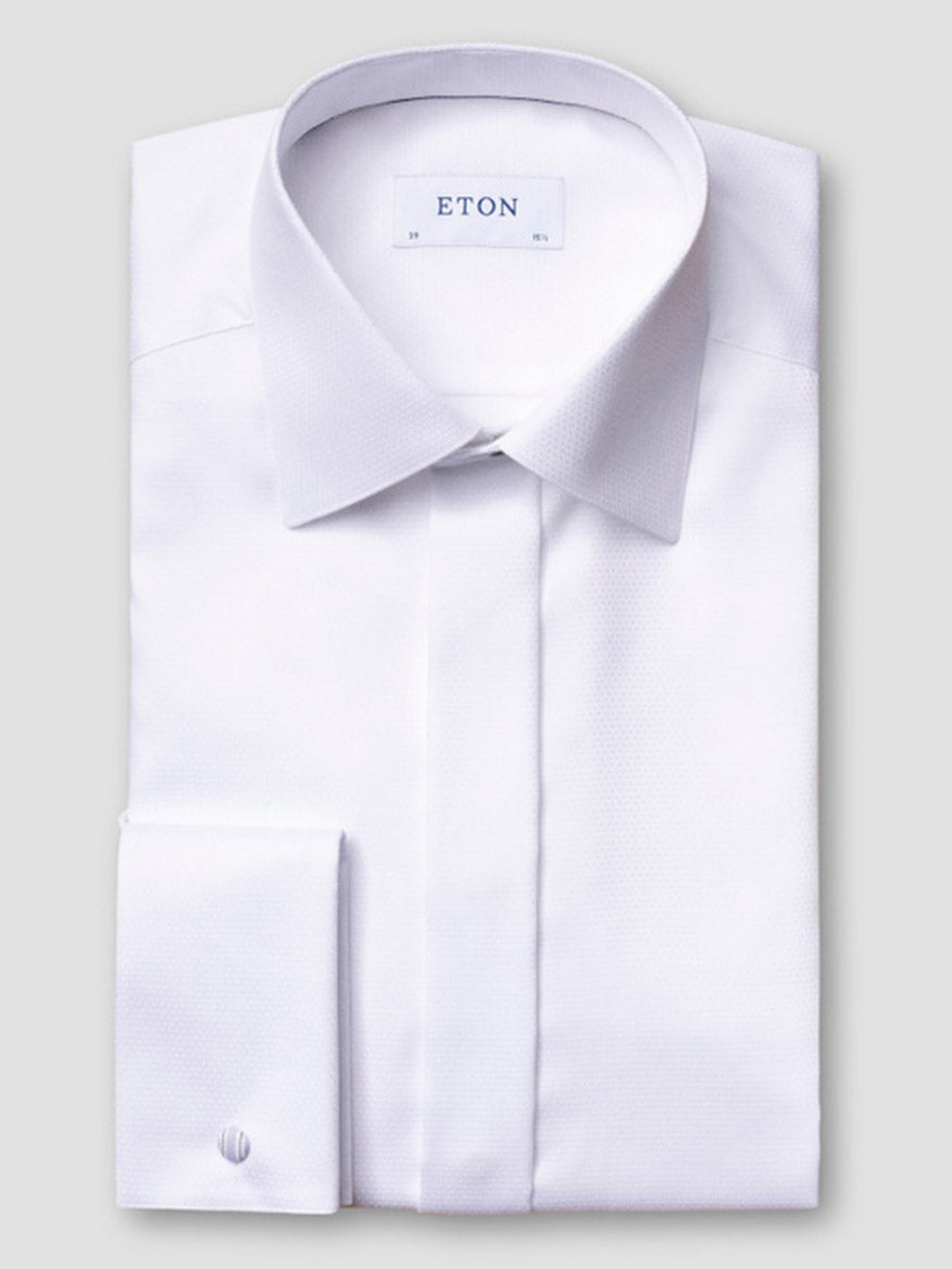 The Eton Contemporary Fit White Dobby Formal Shirt features French cuffs and a pointed collar, neatly folded with the "ETON" label visible inside the neckline, set against a plain light gray background.