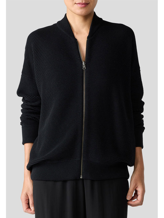 A person is wearing the Eileen Fisher Bomber Cardigan in black, paired with black pants against a plain background, highlighting a minimalist style with the cozy appeal of an organic-cotton blend.