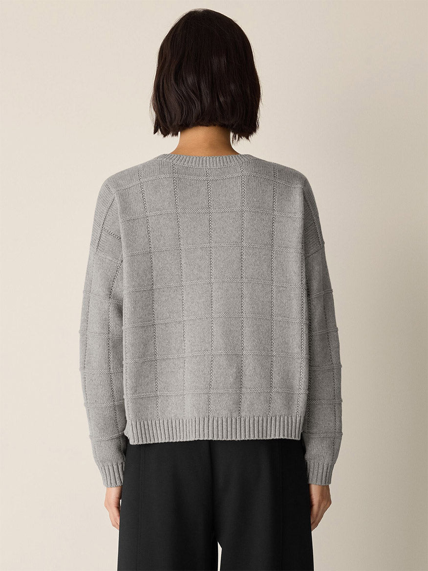 A woman wearing the Eileen Fisher Cotton & Recycled Cashmere Crew Neck Top in Dark Pearl, featuring a subtle knitted grid pattern.