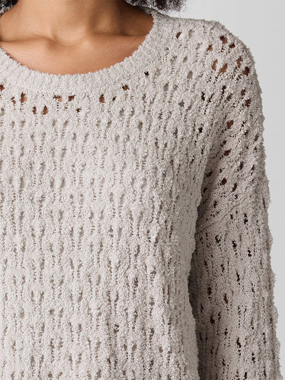 Someone is wearing an Eileen Fisher Cotton Fluff Bracelet Sleeve Top in Bone, featuring textured knit in off-white and cozy details like bracelet sleeves and a fluffy crew neck.