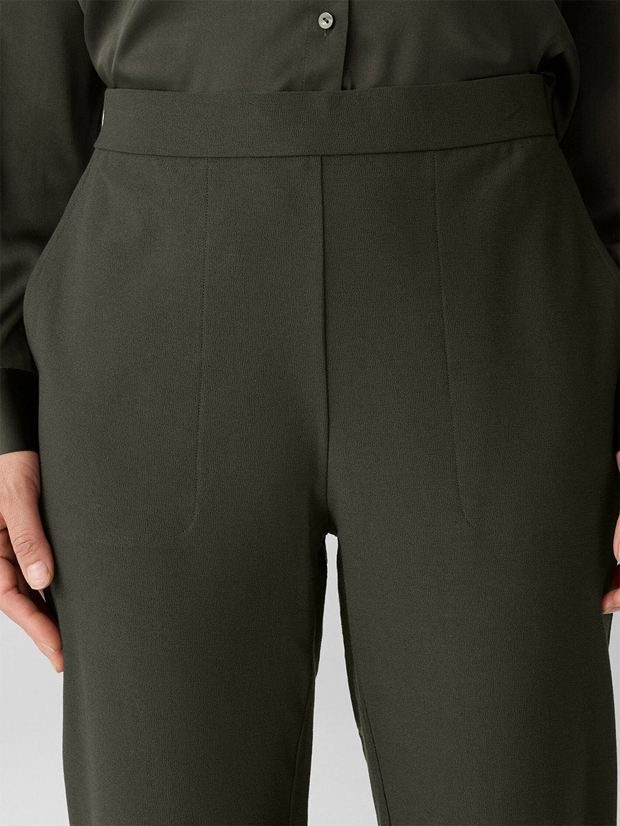 A close-up of a person wearing Eileen Fisher Washable Stretch Crepe Cuffed Pant in Woodland and a matching shirt, with hands relaxed at their sides.