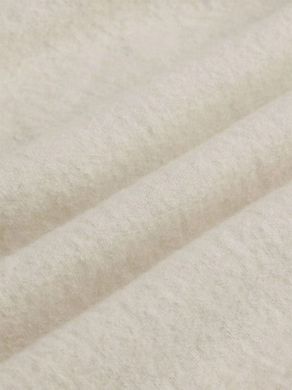 Close-up of an Eileen Fisher Fine Felted Wool Hooded Cardigan in Regenerative Wool in Plaster, featuring off-white felted fabric with soft folds.