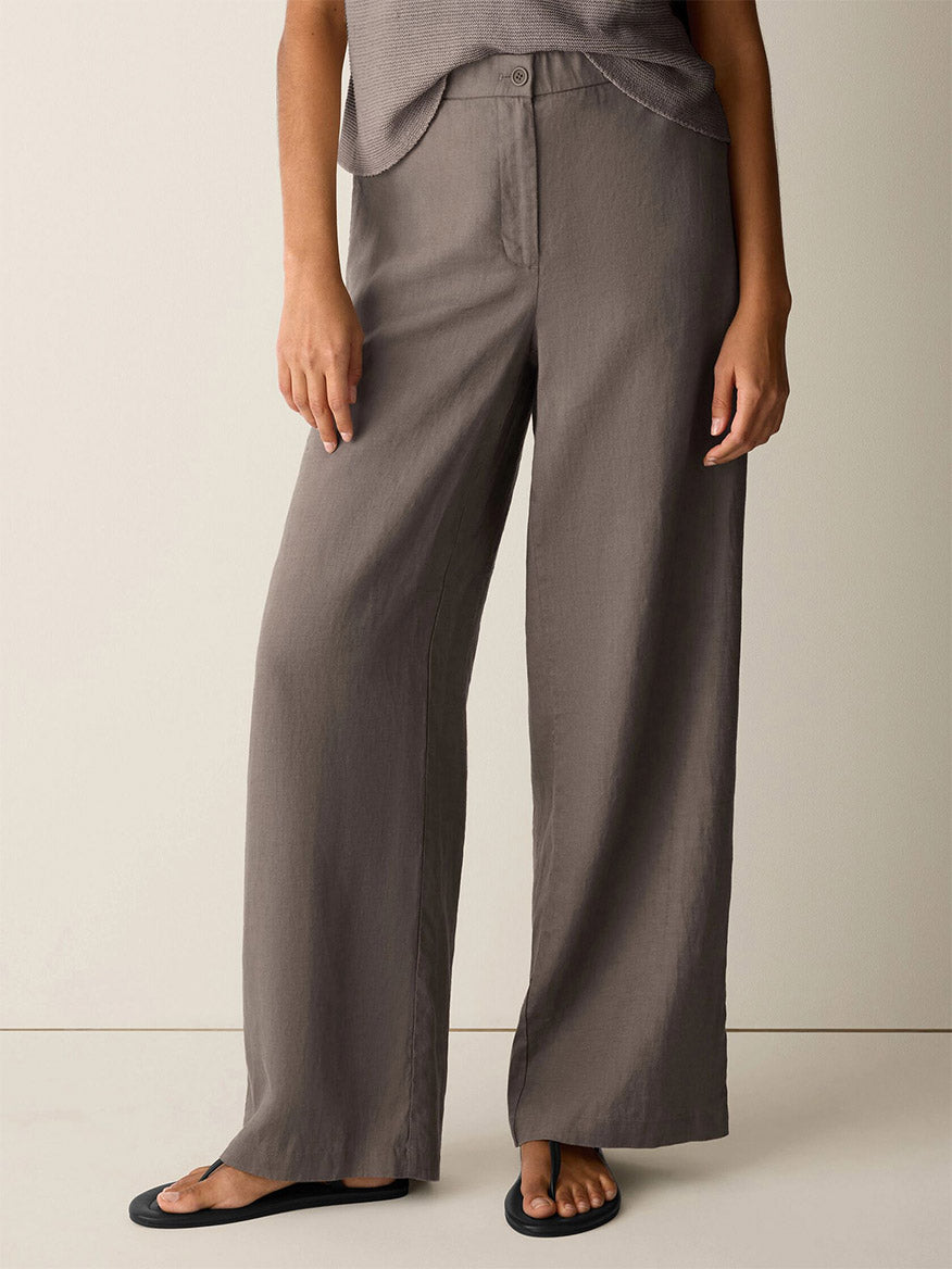Person wearing Eileen Fisher Organic Linen Full-Length Trouser in Walnut with a taupe sleeveless top and black sandals, standing against a plain light background.