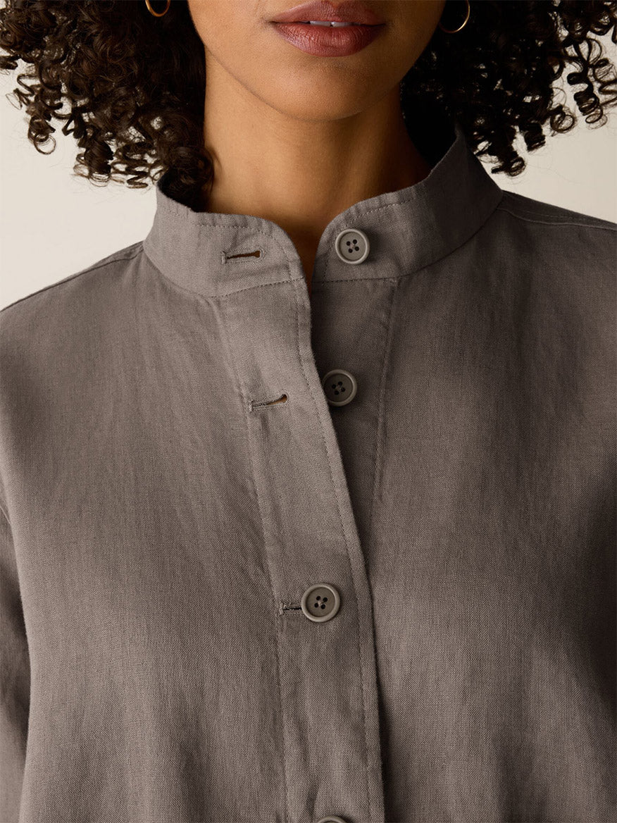 A close-up of a woman wearing the Eileen Fisher Organic Linen Flight Jacket in Walnut; only her lower face and upper chest are visible.