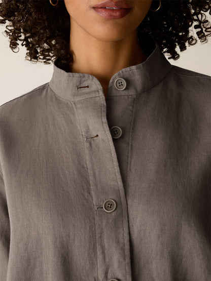A close-up of a woman wearing the Eileen Fisher Organic Linen Flight Jacket in Walnut; only her lower face and upper chest are visible.