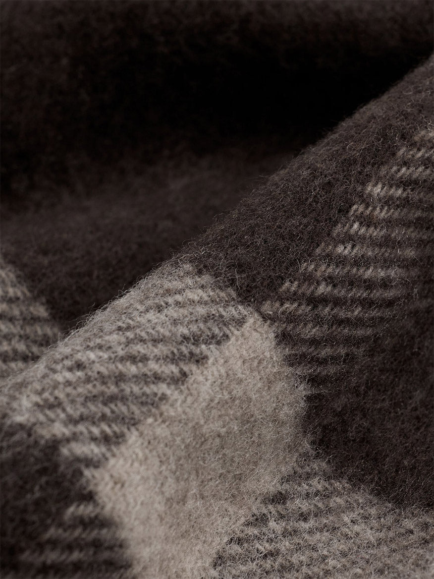 Close-up of the Eileen Fisher Soft Wool Plaid Serape in Coffee, a brown and grey recycled wool serape featuring a graphic grid pattern.