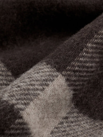 Close-up of the Eileen Fisher Soft Wool Plaid Serape in Coffee, a brown and grey recycled wool serape featuring a graphic grid pattern.