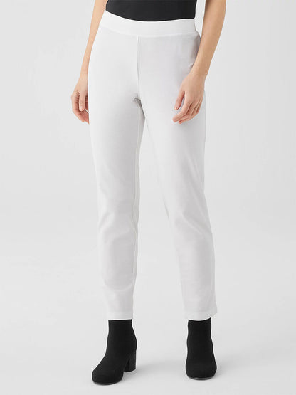 A person is wearing Eileen Fisher Washable Stretch Crepe Pant in White and black heeled boots, set against a neutral background.