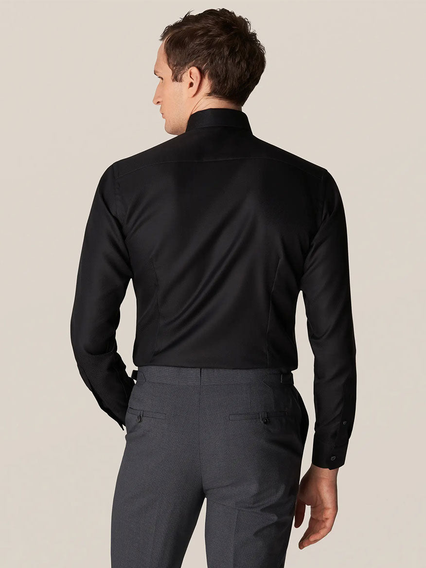 The back view of a man wearing an Eton Contemporary Fit Black Textured Twill Dress Shirt, featuring a contemporary fit.