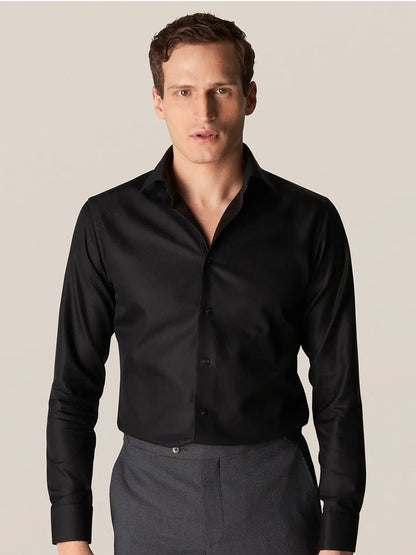 A man wearing an Eton Contemporary Fit Black Textured Twill Dress Shirt.