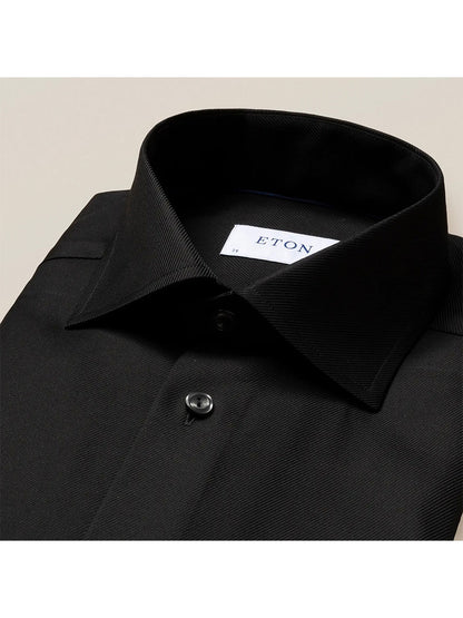 The Eton Slim Fit Black Textured Twill Dress Shirt features a buttoned collar and is the epitome of refined business attire, offering a structured texture for a sophisticated look.