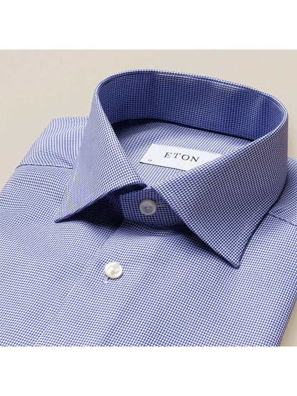 A Eton Contemporary Fit Mid Blue Patterned Twill Dress Shirt with a white stripe on the collar, featuring a contemporary fit and textured structure.