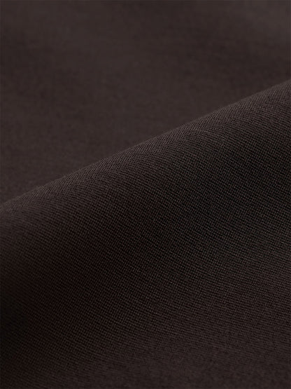 Close-up of folded dark brown knit fabric in the Eileen Fisher Extra-Fine Ponte Kick Pant in Coffee.