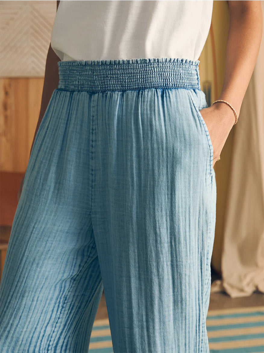 Close-up of a person wearing Faherty Brand Dream Cotton Gauze Wide Leg Pant in Light Indigo Wash with an elastic waistband.