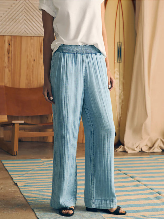 Person standing in a casual stance wearing Faherty Brand Dream Cotton Gauze Wide Leg Pant in Light Indigo Wash and a white t-shirt with their head cropped out of the image.
