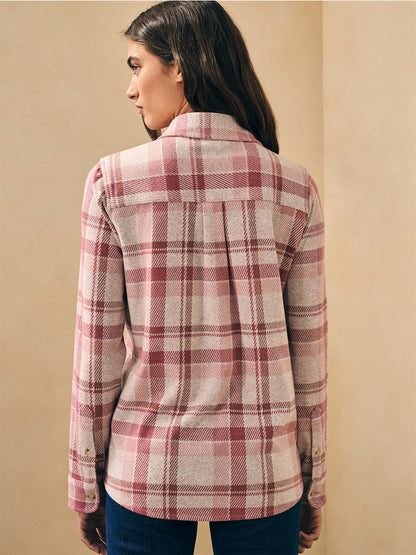 The back view of a woman wearing a Faherty Brand Legend Sweater Shirt in Amelia Plaid.