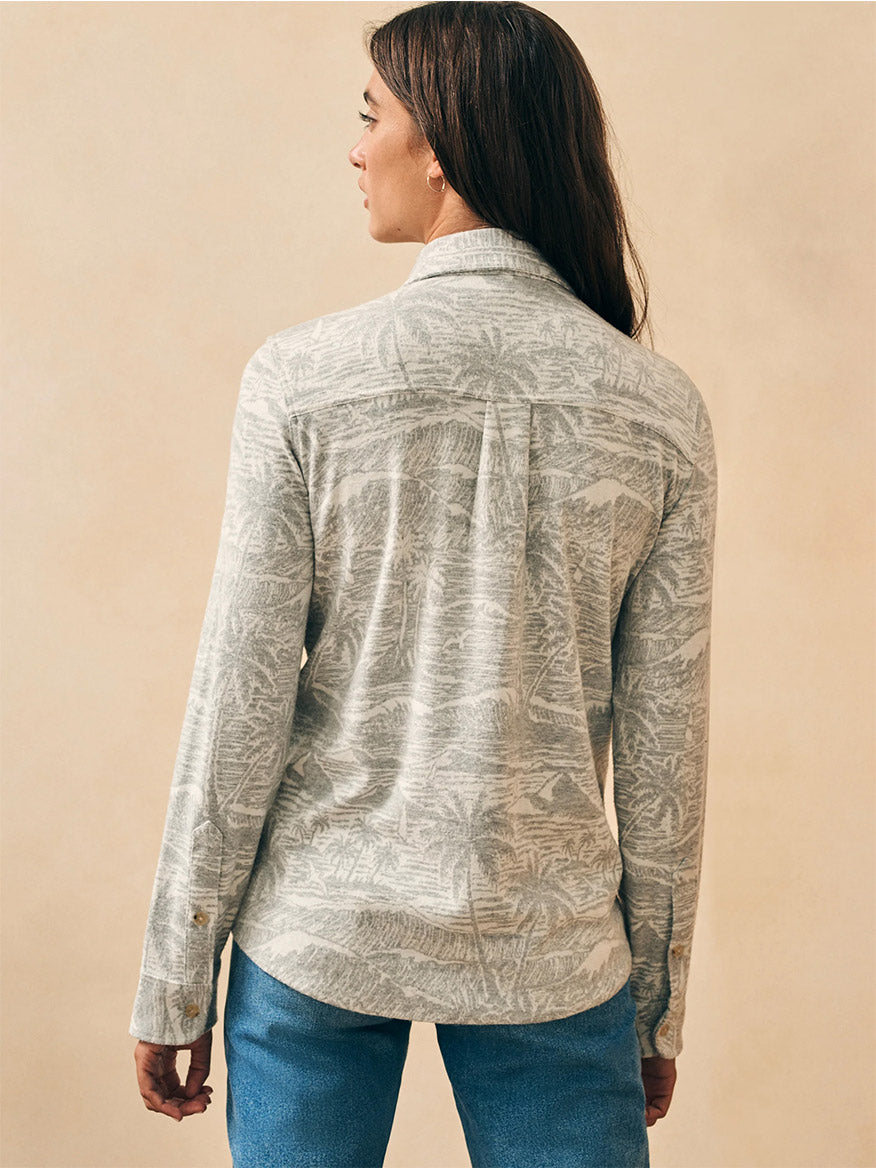 The back view of a woman wearing a Faherty Brand Legend Sweater Shirt in Grey Coastal Waters.