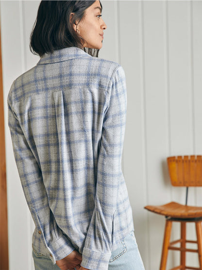 The back view of a woman wearing a Faherty Brand Legend Sweater Shirt in Spring Dew Plaid.