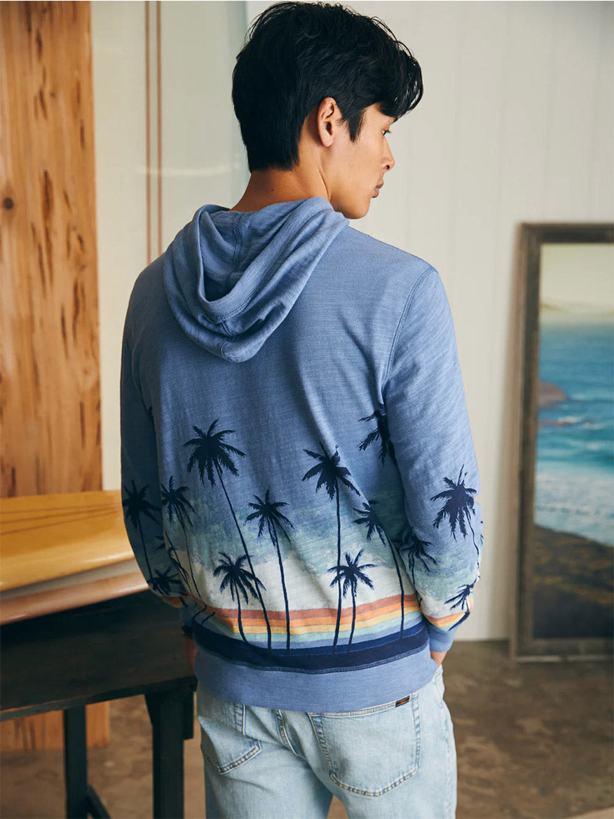 Man wearing a Faherty Brand Sunwashed Slub Hoodie in Palm Rainbow Ombre from behind, crafted in slub knit fabric.