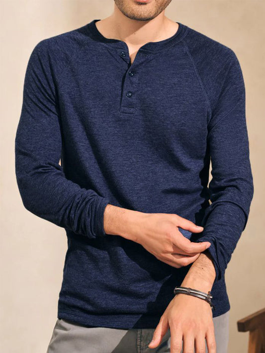 A person wearing the Faherty Brand Cloud Cotton Long-Sleeve Henley in Baltic Navy Heather adjusts their sleeve.