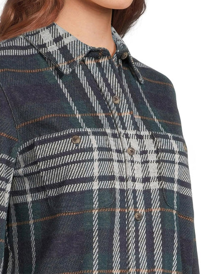 Close-up of a person wearing the Faherty Brand Legend Sweater Shirt in Blue Ridge Plaid. This soft knit shirt features two chest pockets and a collar, crafted with a custom fabric blend for comfort.