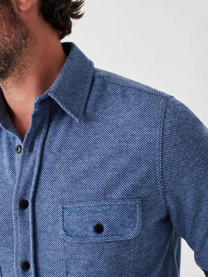 A person wearing the Faherty Brand Legend Sweater Shirt in Glacier Blue Twill, made from a soft knit fabric for comfort and ideal for layering, visible from the chest up.