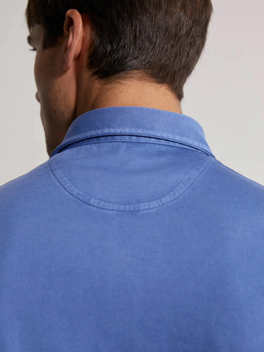 Close-up of a man's back showing the collar of a Fedeli Organic Giza Cotton Polo in Ocean.