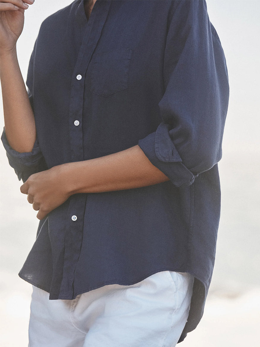 Wearing the Frank & Eileen Eileen Relaxed Button-Up Shirt in Navy Washed Linen and white pants, this look captures effortless California style with a breezy outdoor vibe and flattering button placement.