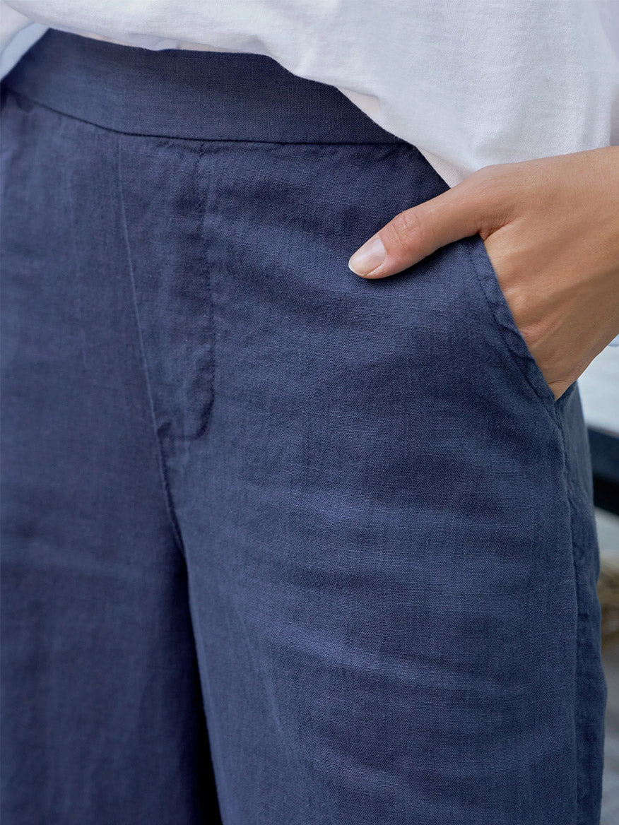 Person wearing the Frank & Eileen Maisie Wide-Leg Pull-On Pant in Navy Washed Linen and a white top, with one hand in their pocket.