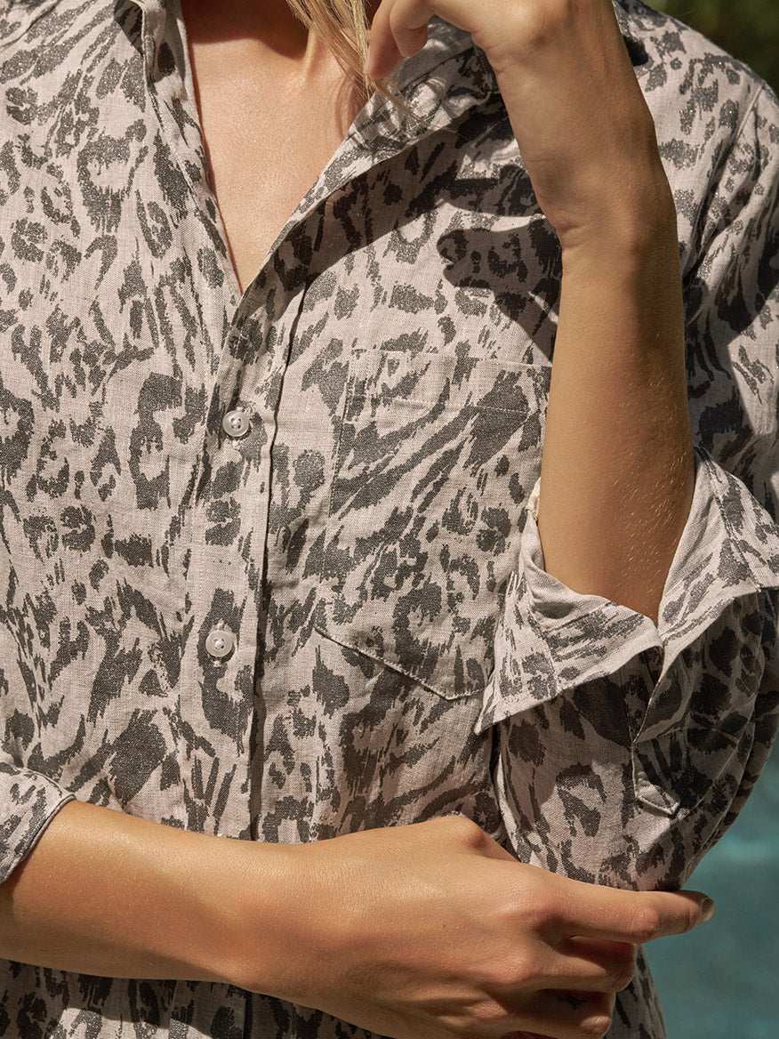 Wearing the Frank & Eileen Rory Maxi Shirtdress in Glitter Animal Print, styled with California chic flair, a person stands outdoors by the pool with arms crossed and one hand touching the collar.