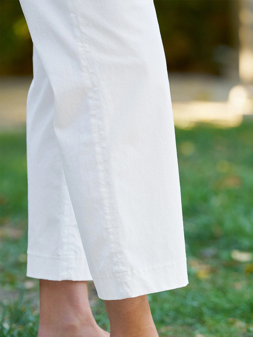 A person stands barefoot on grass, wearing Frank & Eileen Westport Italian Wide-Leg Chino in White.