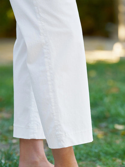 A person stands barefoot on grass, wearing Frank & Eileen Westport Italian Wide-Leg Chino in White.