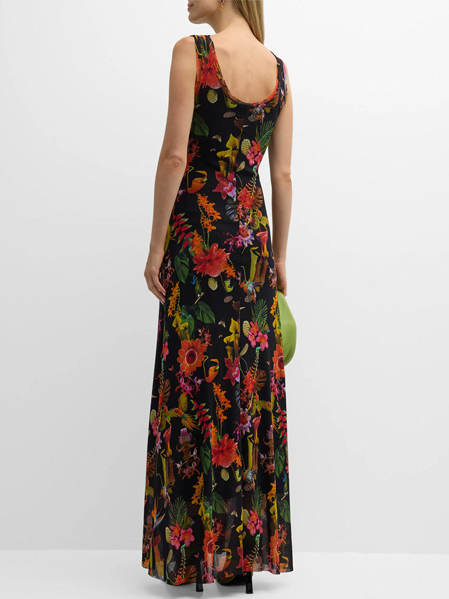 A woman viewed from behind wearing a Fuzzi Abito Floral Sleeveless Dress in Nero Multi and holding a green handbag.