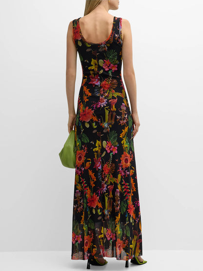 Woman standing in a Fuzzi Abito Floral Sleeveless Dress in Nero Multi with a green handbag.