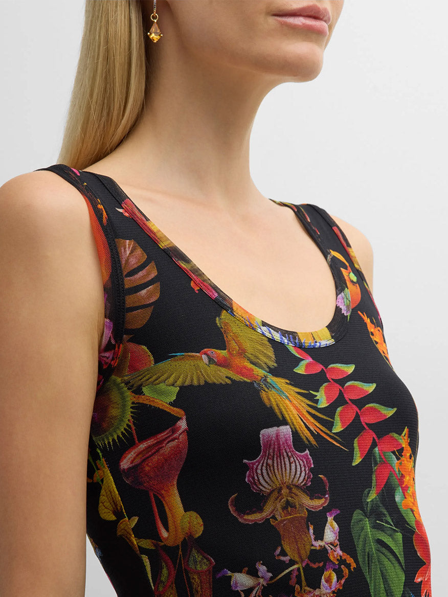 Woman wearing a Fuzzi Abito Floral Sleeveless Dress in Nero Multi with a colorful tropical print.