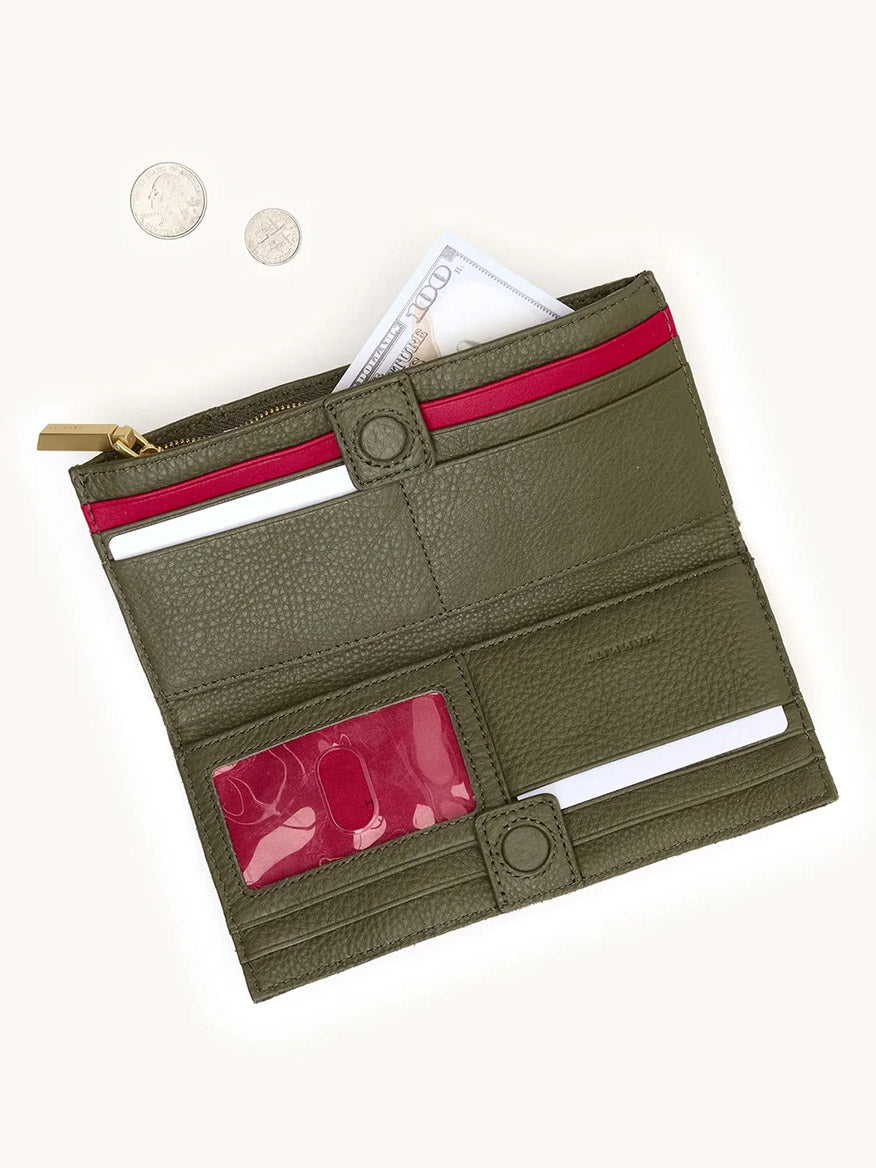 The Hammitt Los Angeles 110 North Wallet in Olive/Brushed Gold is shown open, revealing multiple card slots and a zippered cash pocket, with two coins beside it on a light background.