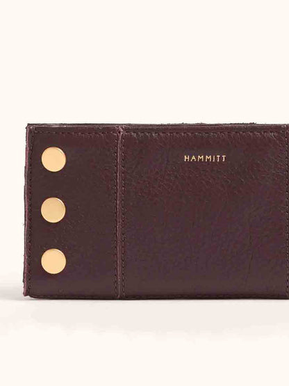 The Hammitt Los Angeles 110 North Wallet in Cabernet Pebble, with gold rivets and the "HAMMITT" text on the front, features convenient credit card slots.